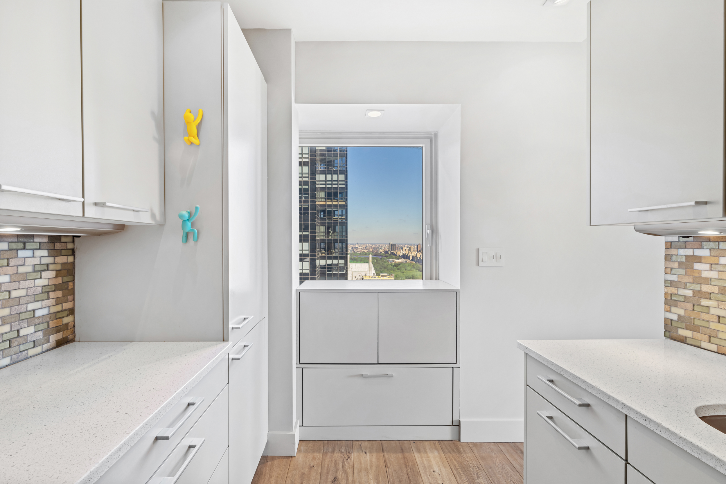 150 West 56th Street, Unit 4802 Manhattan, NY 10019 - Photo 4 of 13 a kitchen with a sink and cabinets