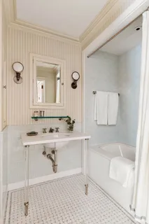 a bathroom with a bathtub a sink and a mirror