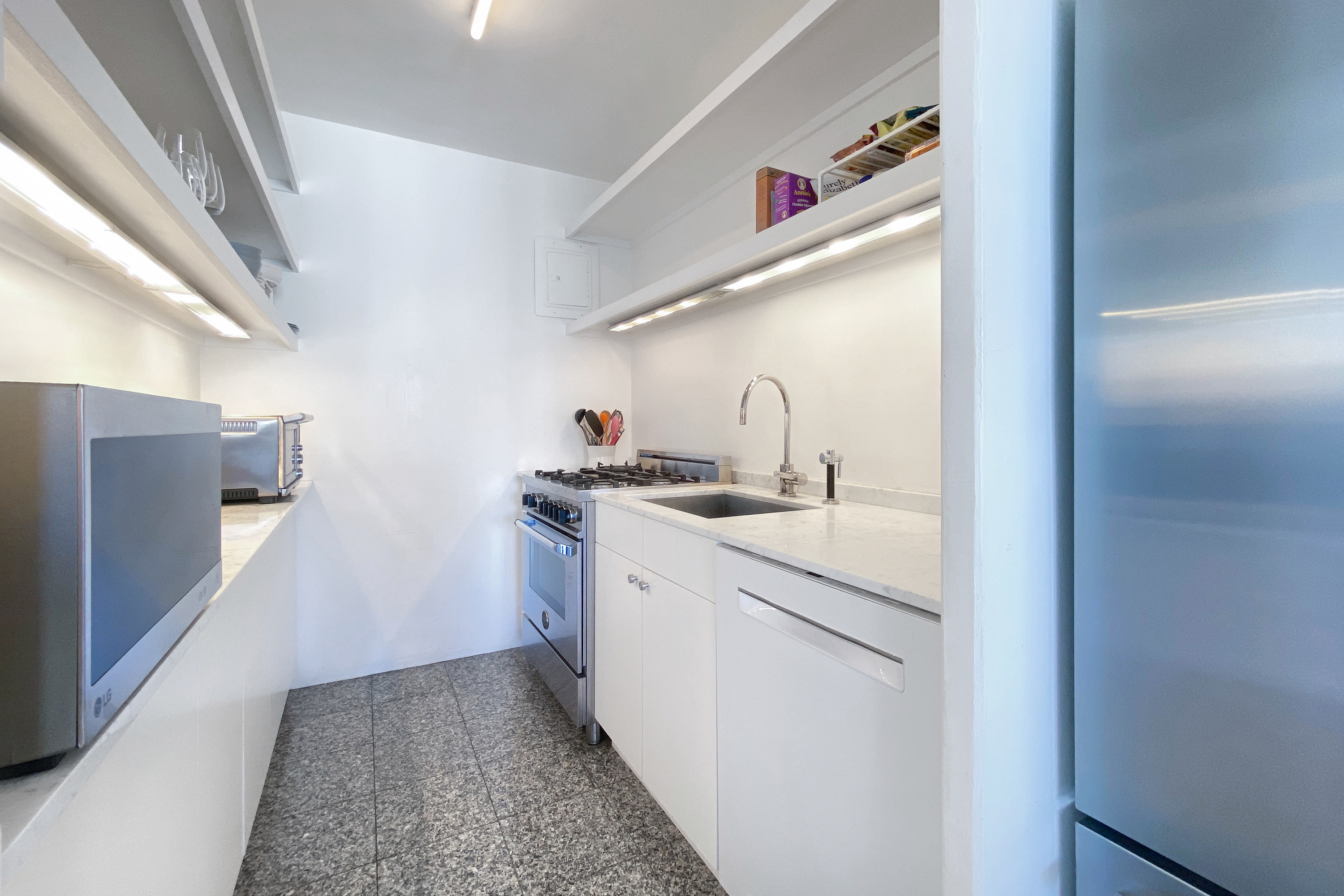 343 East 30th Street, Unit 18A Manhattan, NY 10016 - Photo 5 of 17 a kitchen with a sink and refrigerator
