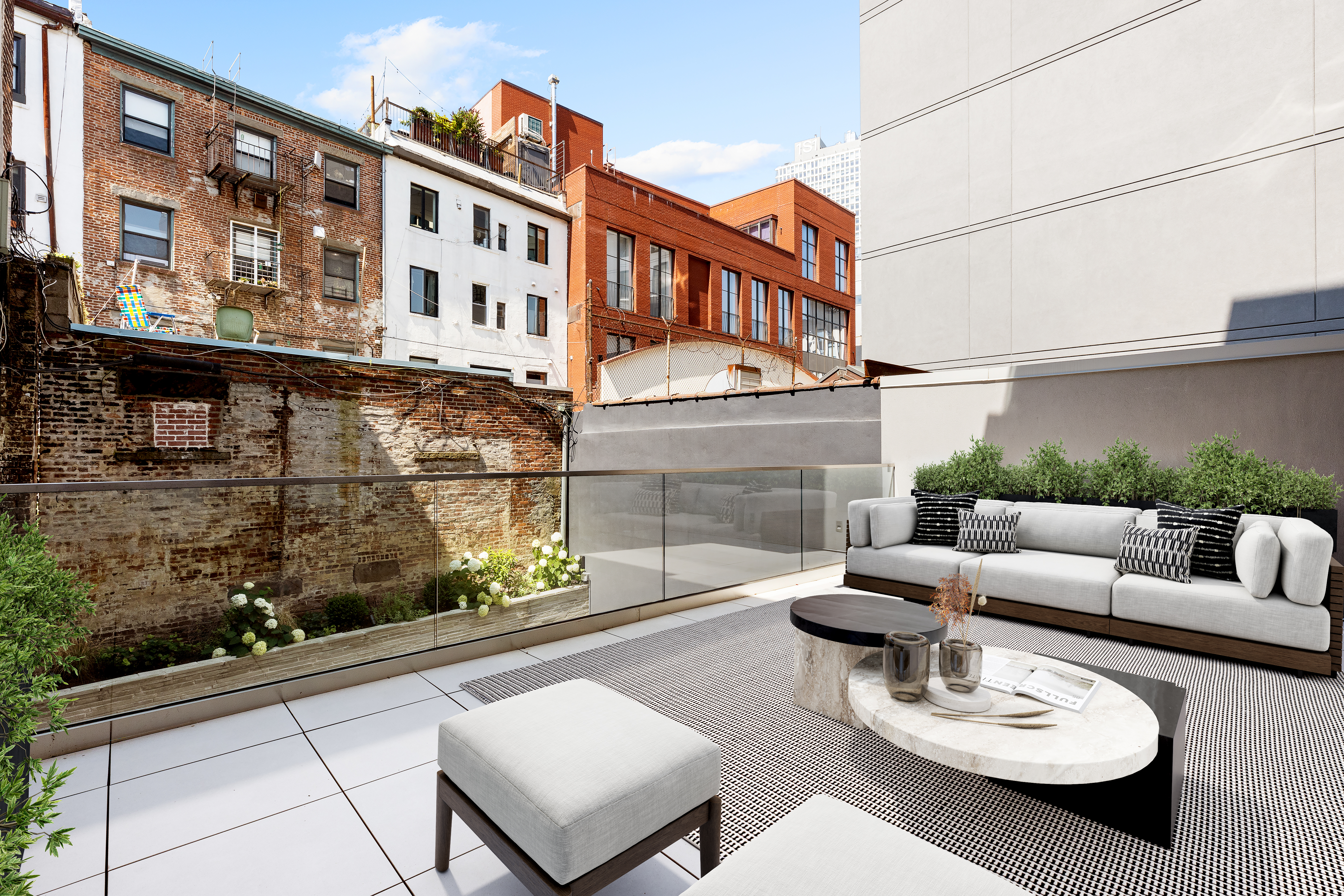96 North 1st Street, Unit TH1 Brooklyn, NY 11249 - Photo 3 of 13 a view of a patio with couches table and chairs with potted plants
