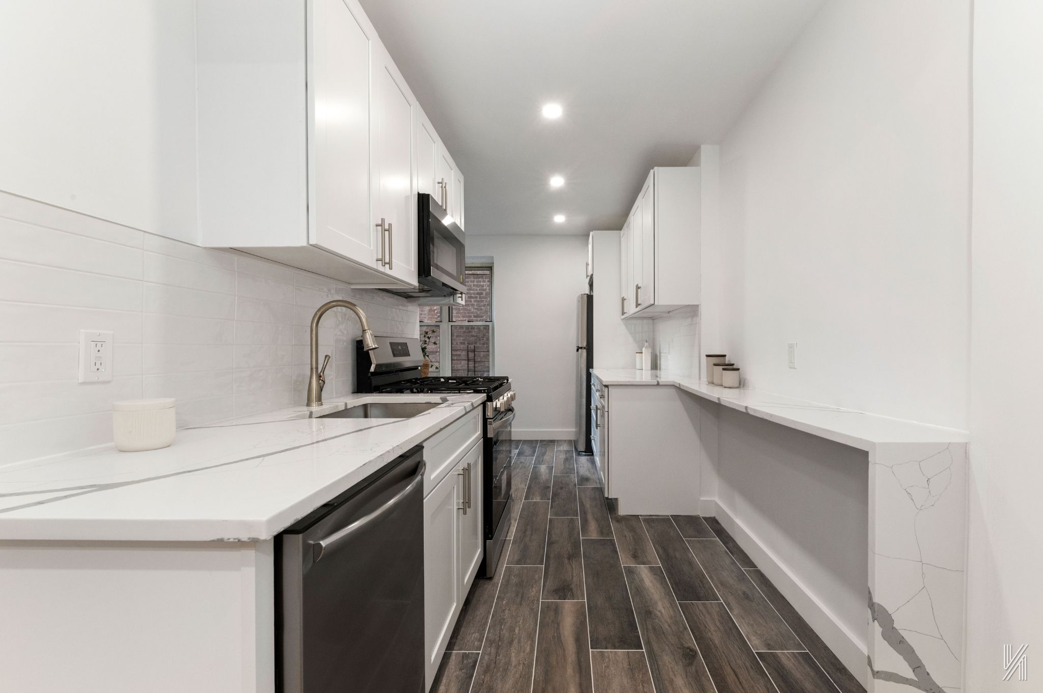 34-41 85th Street, Unit 1U Queens, NY 11372 - Photo 8 of 24 a kitchen with a sink a refrigerator and cabinets