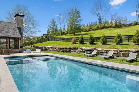 a view of swimming pool with outdoor seating and yard