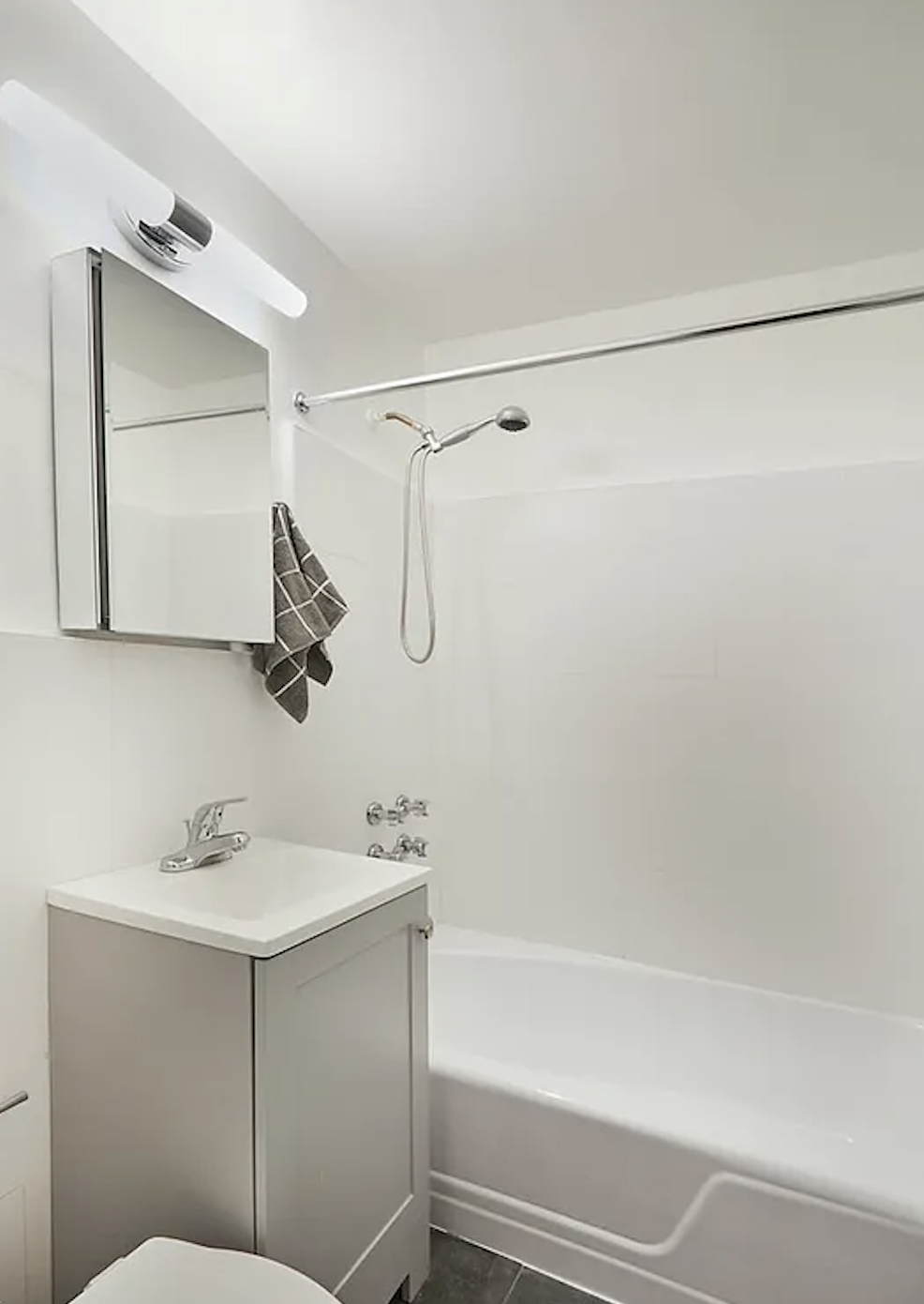 405 East 82nd Street, Unit 1B Manhattan, NY 10028 - Photo 7 of 10 a bathroom with a sink and a mirror