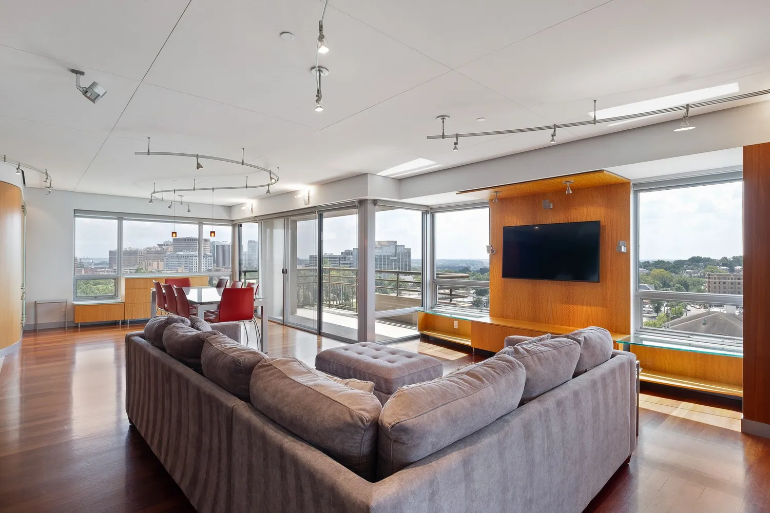 a living room with furniture floor to ceiling window and pool table