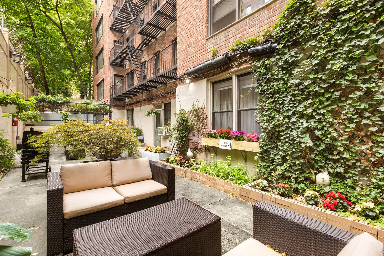 342 East 53rd Street, Unit 1G Manhattan, NY 10022 - Photo 8 of 9 a view of a patio with couches and potted plants