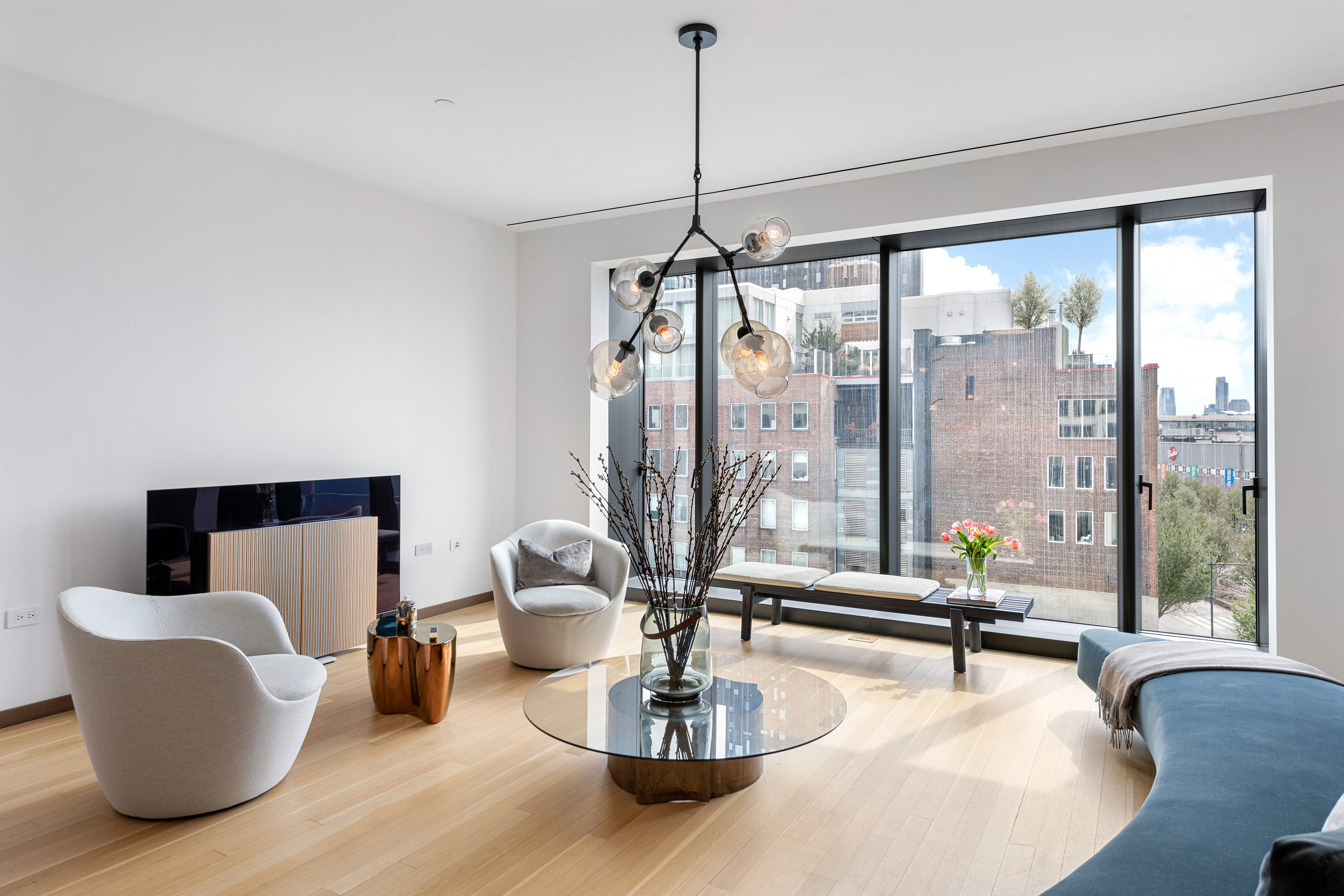 551 West 21st Street, Unit 4D Manhattan, NY 10011 - Photo 3 of 16 a living room with couch and a table