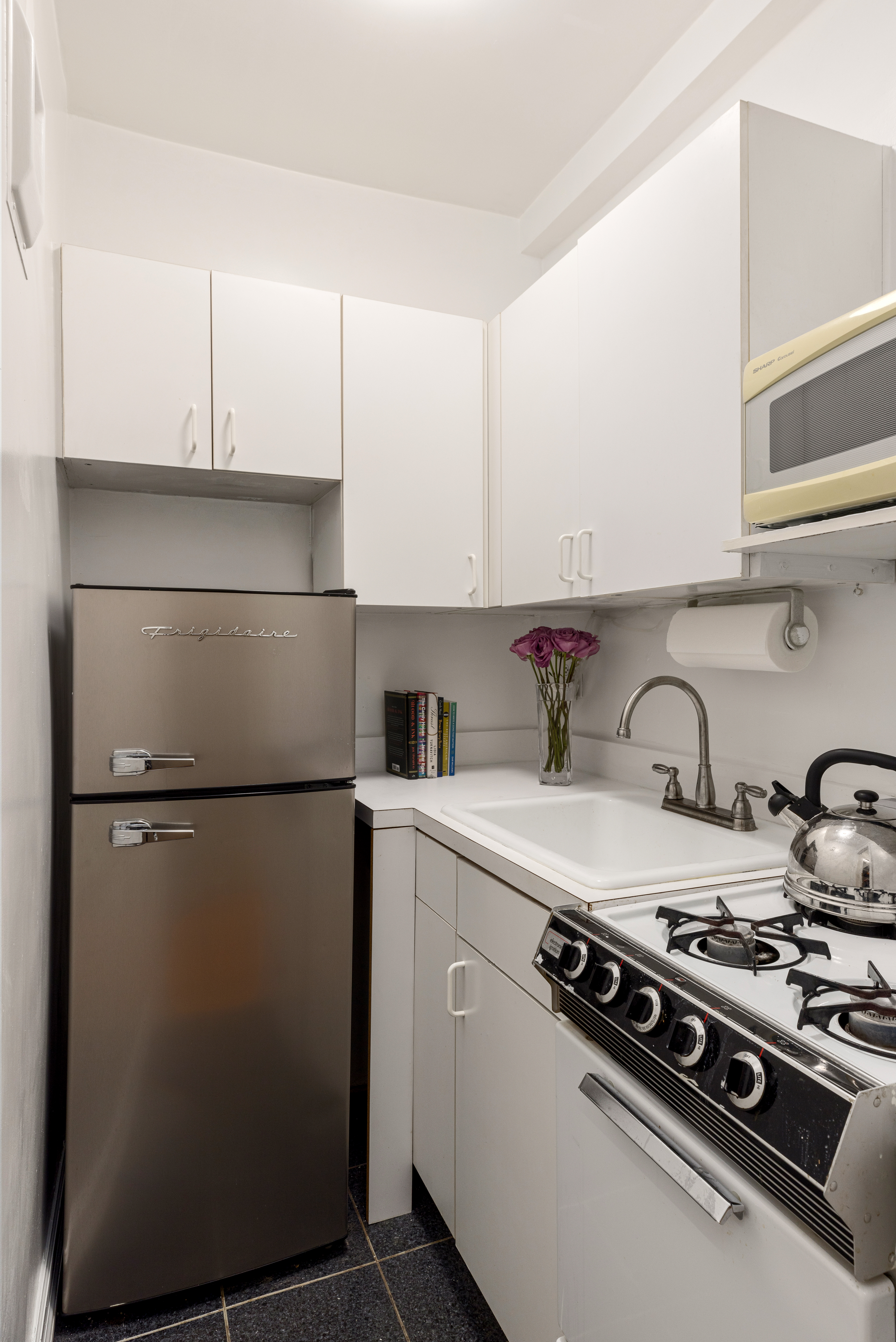 235 West 102nd Street, Unit 4E Manhattan, NY 10025 - Photo 5 of 19 a kitchen with a stove and a refrigerator