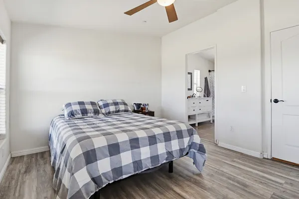 a bedroom with a bed and a chandelier