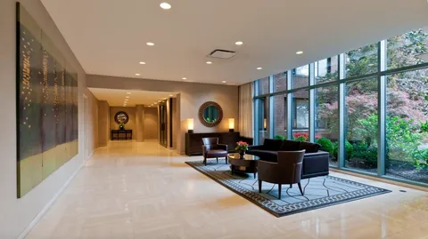 a living room with furniture a rug and a large window