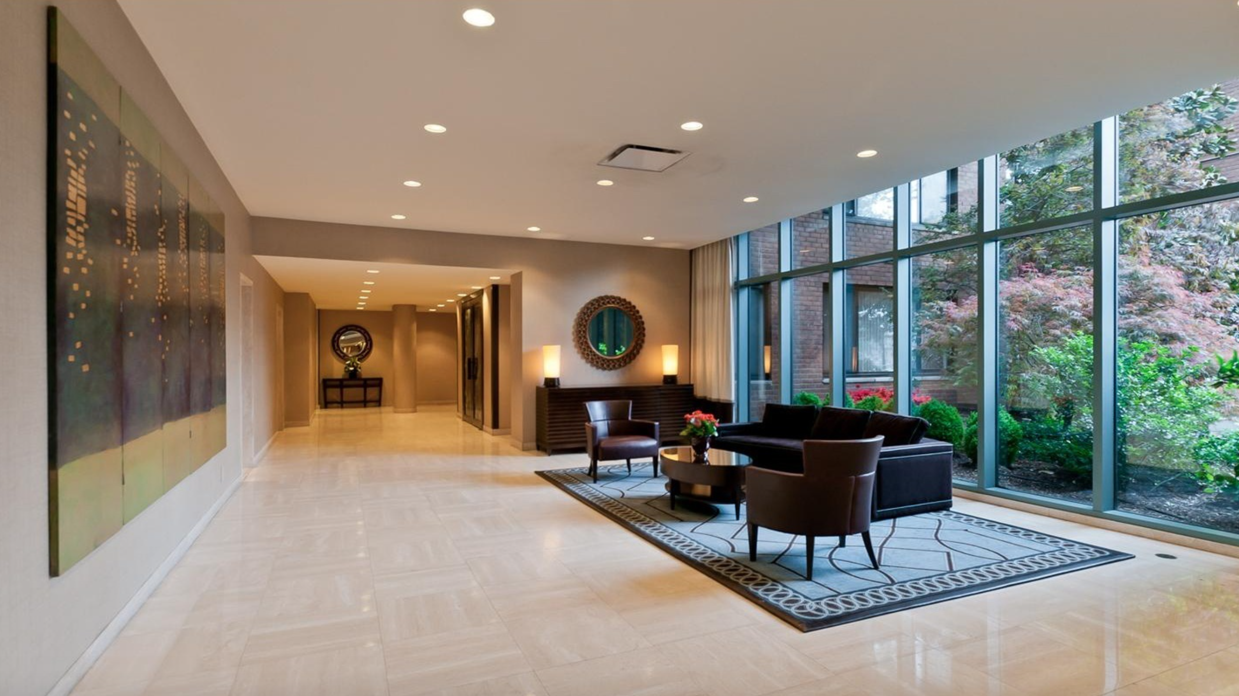 60 Sutton Place South, Unit 9AN Manhattan, NY 10022 - Photo 10 of 12 a living room with furniture a rug and a large window