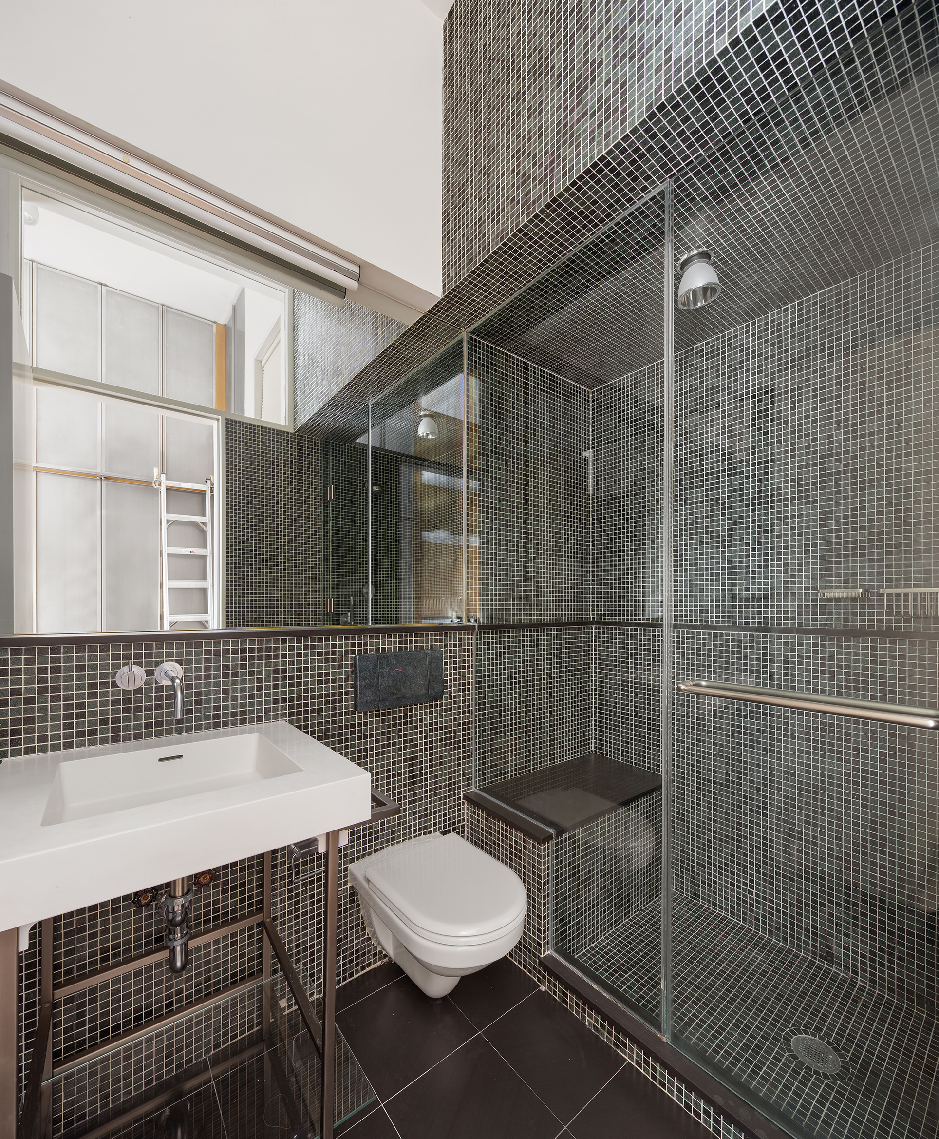 84 Mercer Street, Unit 3E Manhattan, NY 10012 - Photo 18 of 19 a bathroom with a sink a toilet and shower