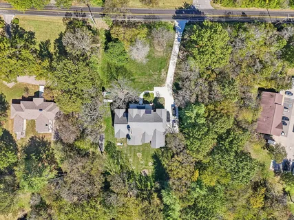 an aerial view of a house with a yard