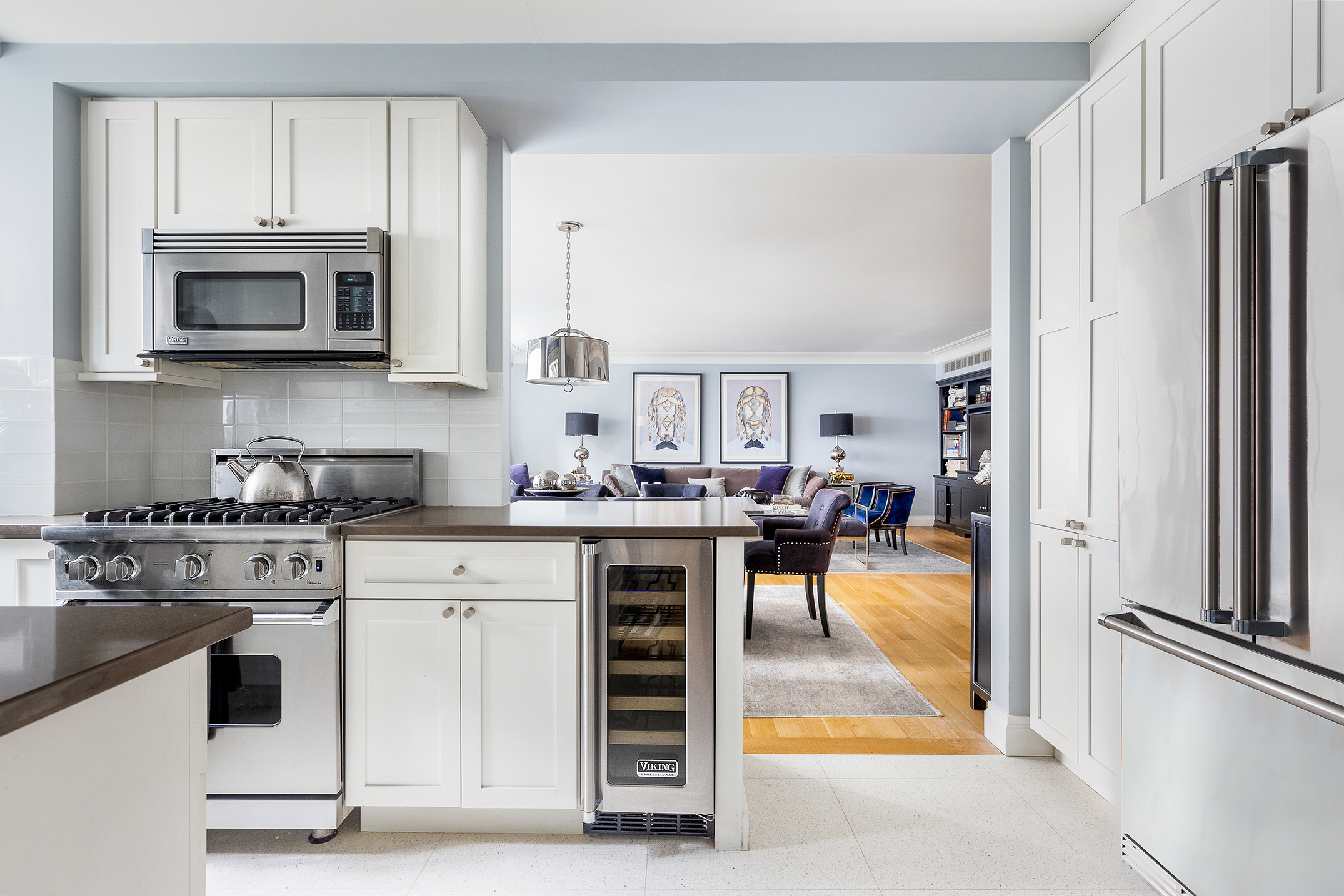 200 East 66th Street, Unit E207 Manhattan, NY 10065 - Photo 5 of 12 a kitchen with white cabinets and white appliances