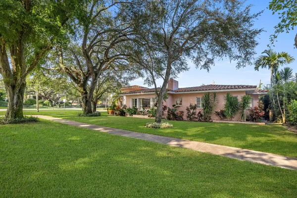 a front view of a house with a garden