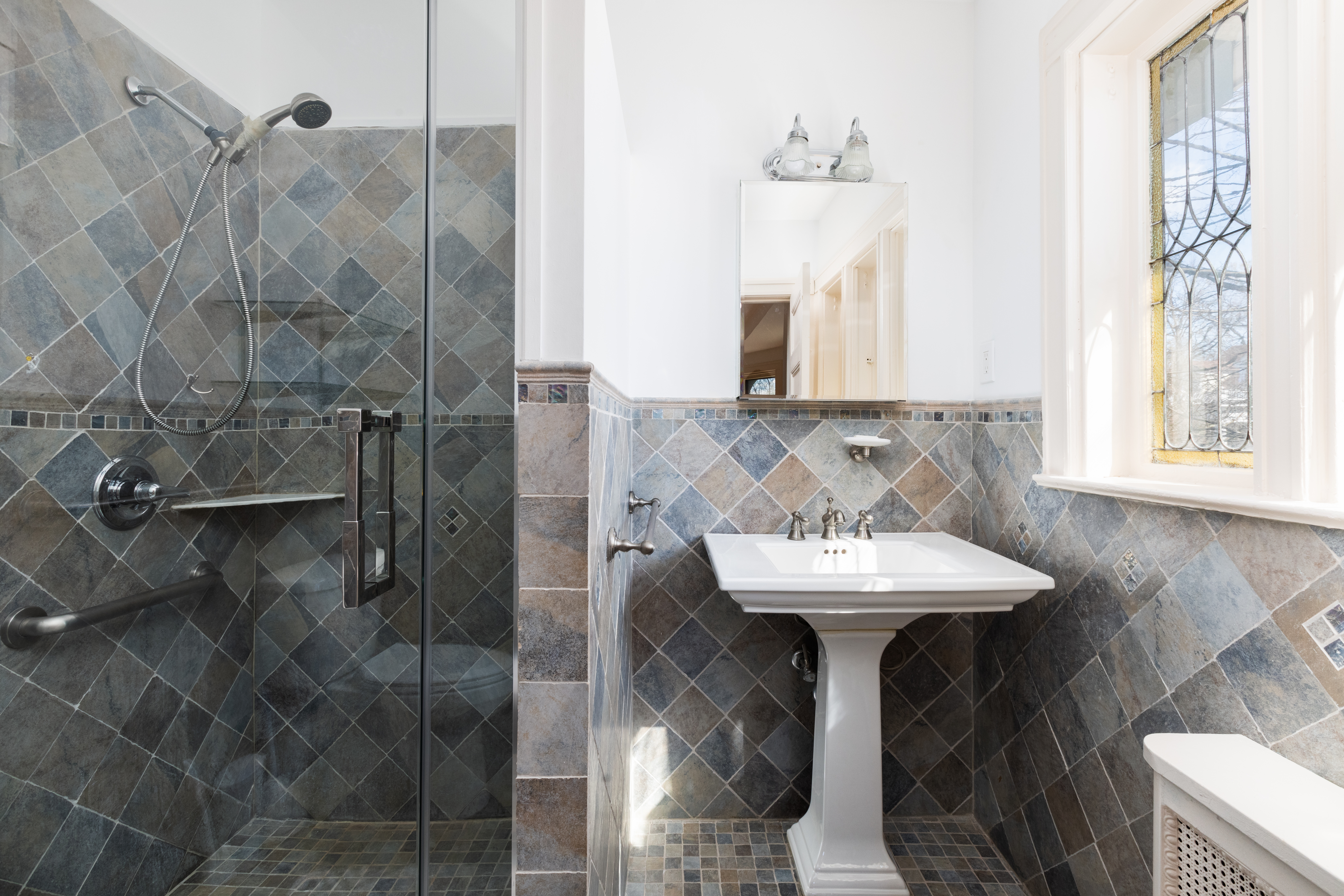 196 Marlborough Road Brooklyn, NY 11226 - Photo 18 of 23 a bathroom with a sink a mirror and shower