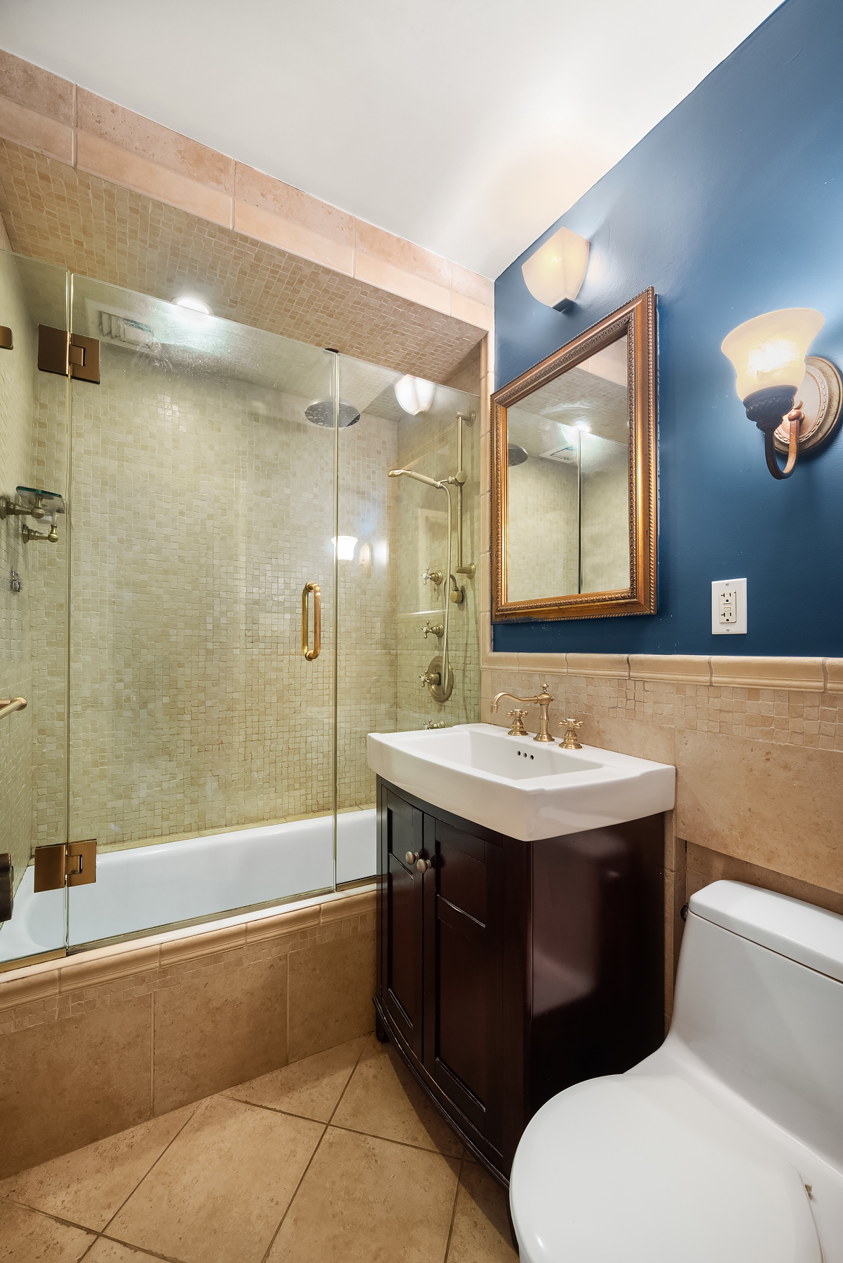 301 East 62nd Street, Unit 2K Manhattan, NY 10065 - Photo 8 of 9 a bathroom with a sink a toilet and bathtub
