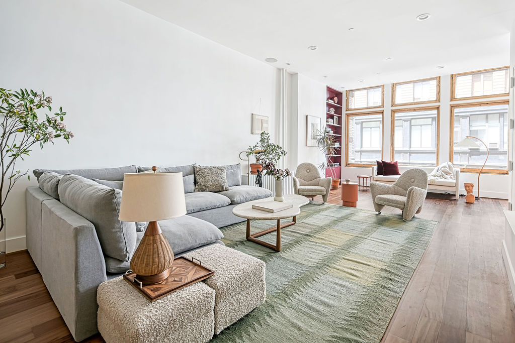 42 East 12th Street, Unit 2 Manhattan, NY 10003 - Photo 16 of 18 a living room with furniture or couch and a large window
