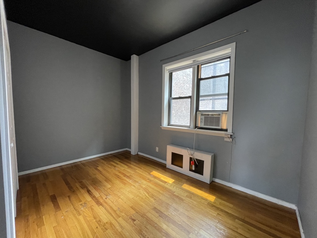 266 West 22nd Street, Unit 2 Manhattan, NY 10011 - Photo 7 of 14 a view of an empty room with wooden floor and a window