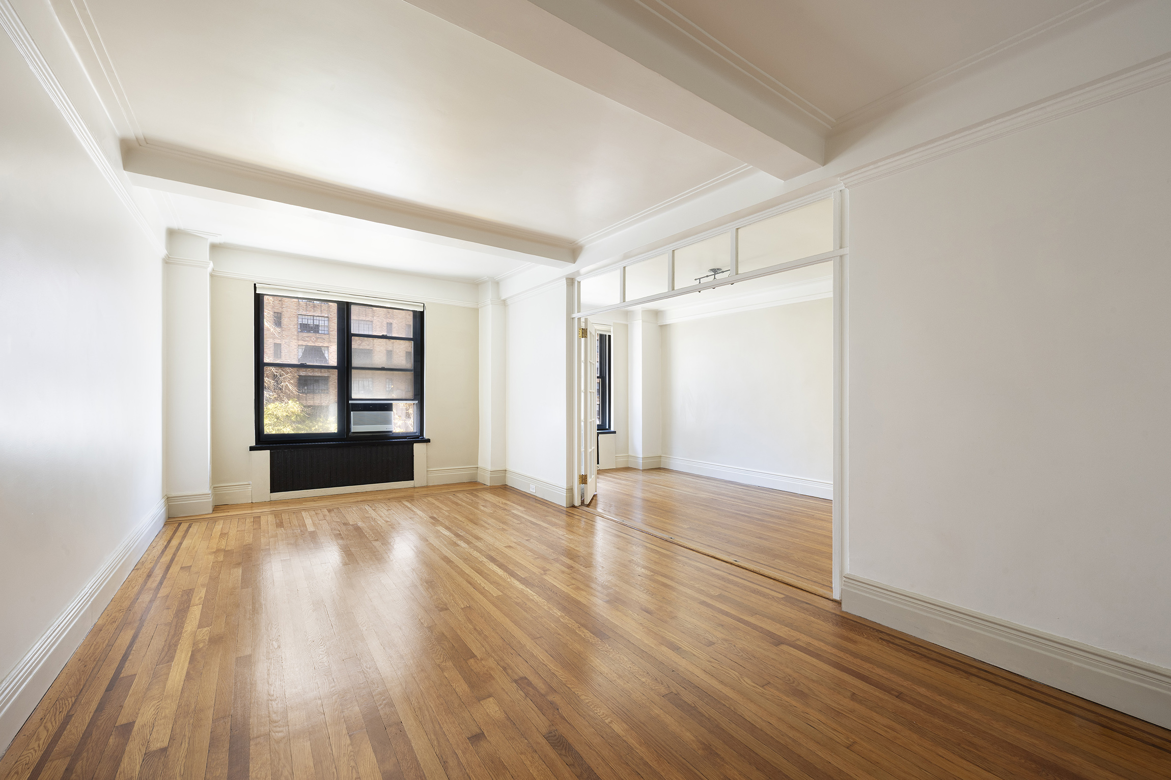 7 Park Avenue, Unit 41 Manhattan, NY 10016 - Photo 1 of 9 wooden floor in an empty room with a window