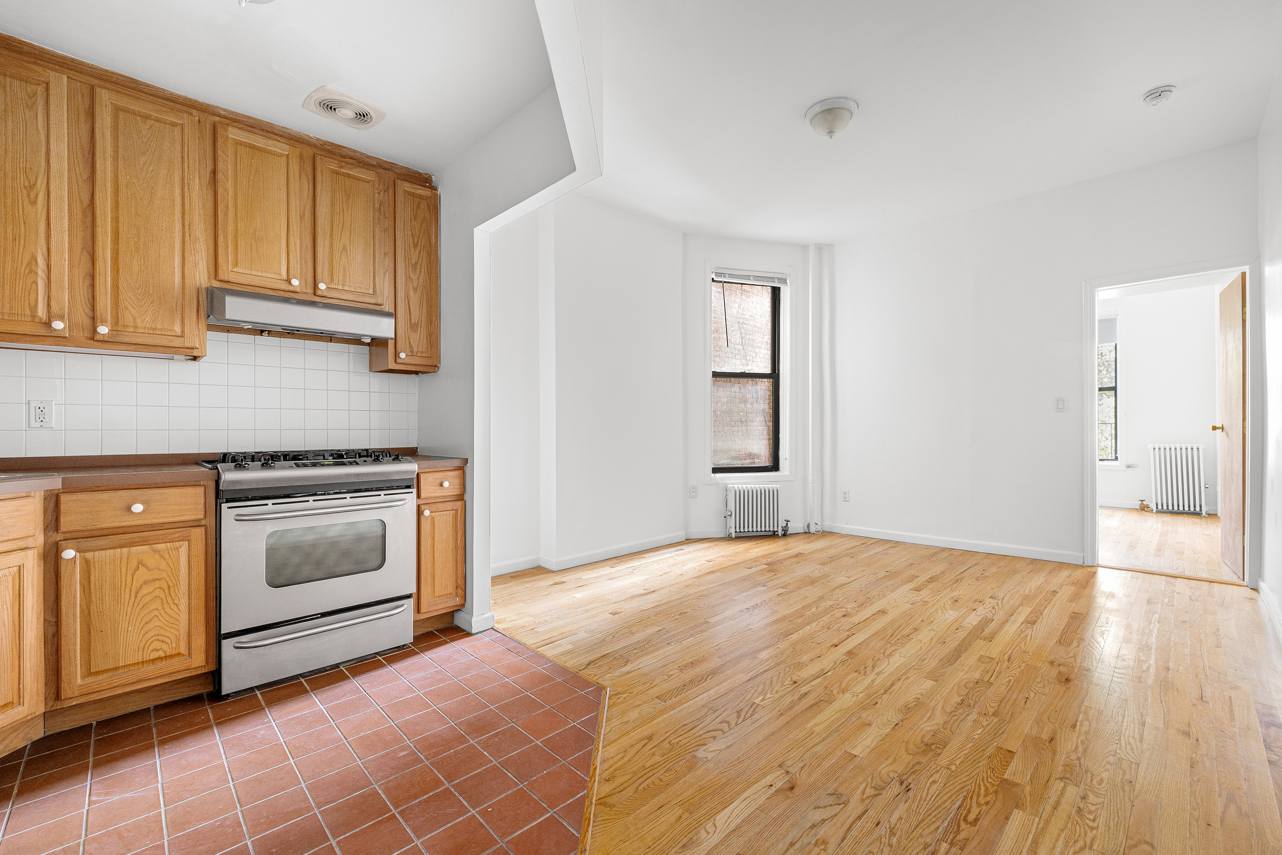 325 3rd Street, Unit 2A Brooklyn, NY 11215 - Photo 5 of 13 a kitchen with granite countertop white cabinets and stainless steel appliances