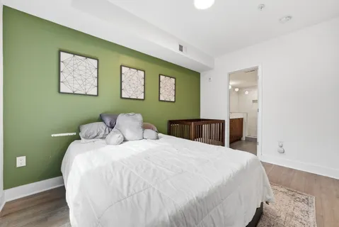 a large bed sitting in a bedroom and a table