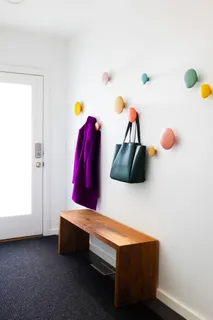 a living room with furniture and a wall painting