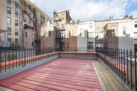 a view of a balcony with wooden floor