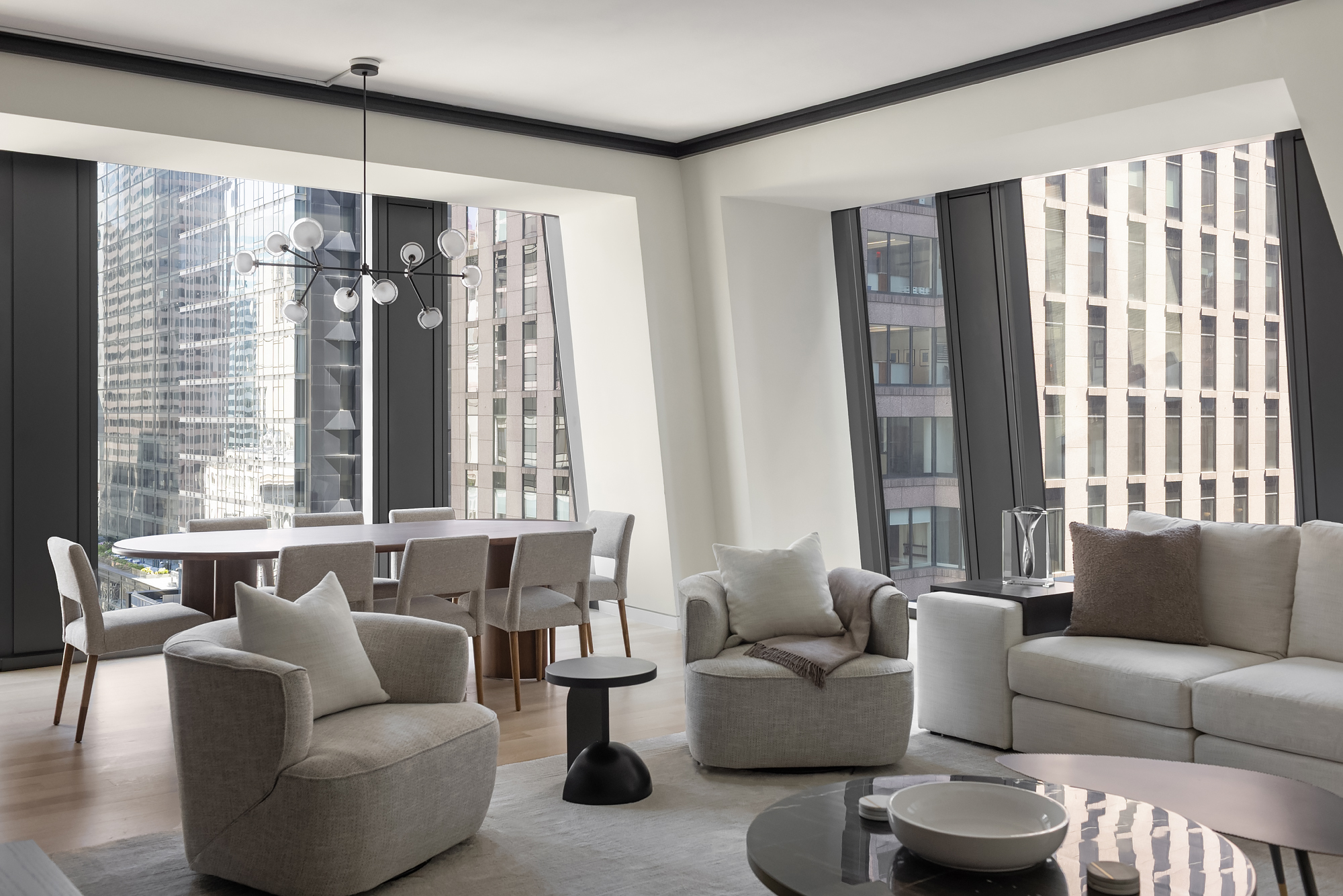 53 West 53rd Street, Unit 23D Manhattan, NY 10019 - Photo 3 of 11 a living room with furniture and a large window