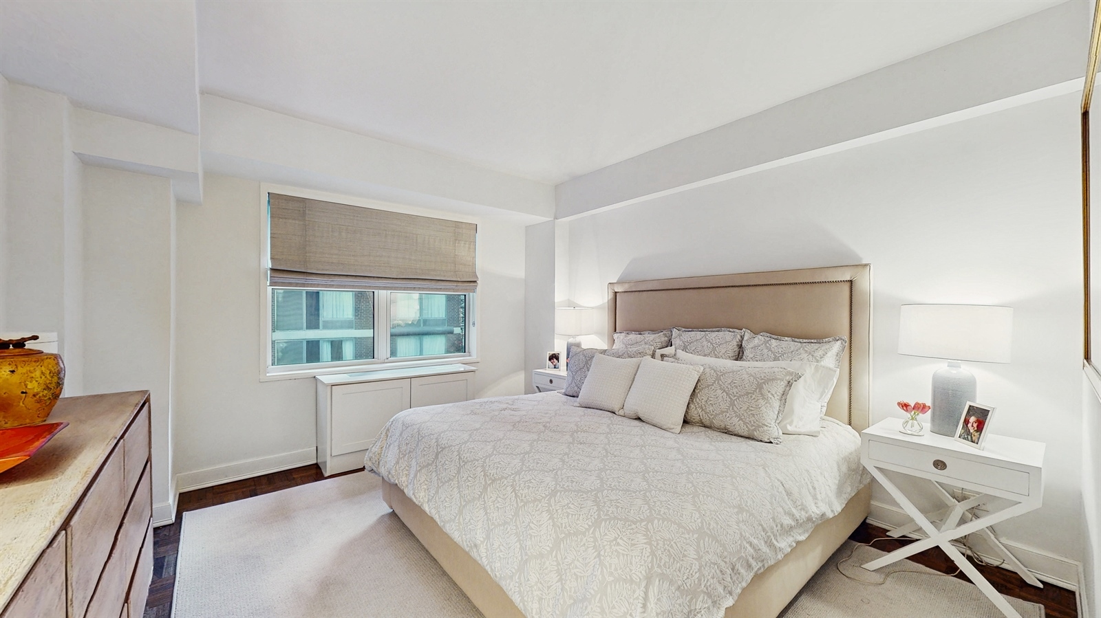 136 East 56th Street, Unit 16B Manhattan, NY 10022 - Photo 6 of 11 a bedroom with a bed and a window
