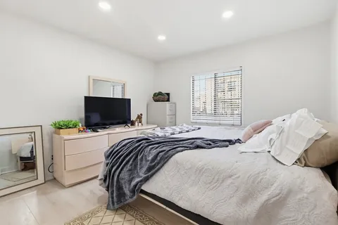 a bedroom with a bed and a flat screen tv
