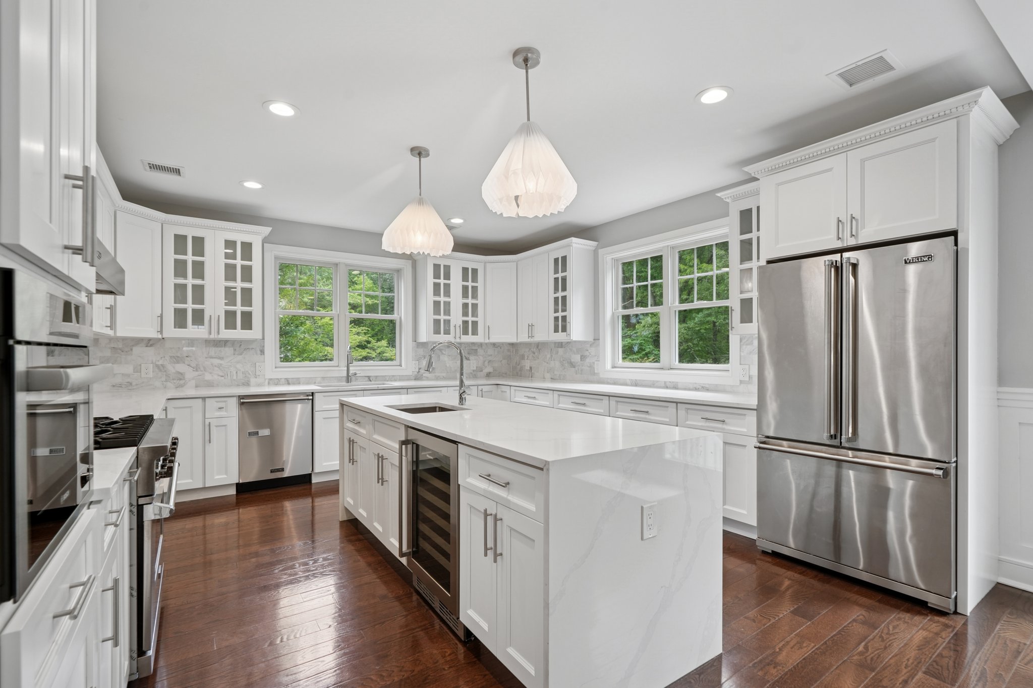 823 River Road Chatham, NJ 07928 - Photo 13 of 60 a kitchen with stainless steel appliances granite countertop a refrigerator a stove a sink dishwasher a dining table and chairs with wooden floor