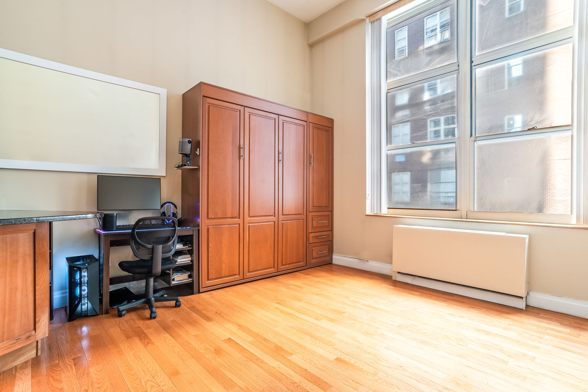 120 East 87th Street, Unit R6L Manhattan, NY 10028 - Photo 1 of 19 a view of an empty room with furniture and a window