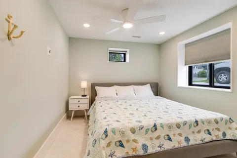 a bedroom with a bed and a mirror