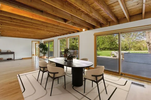 a dining room with furniture and window