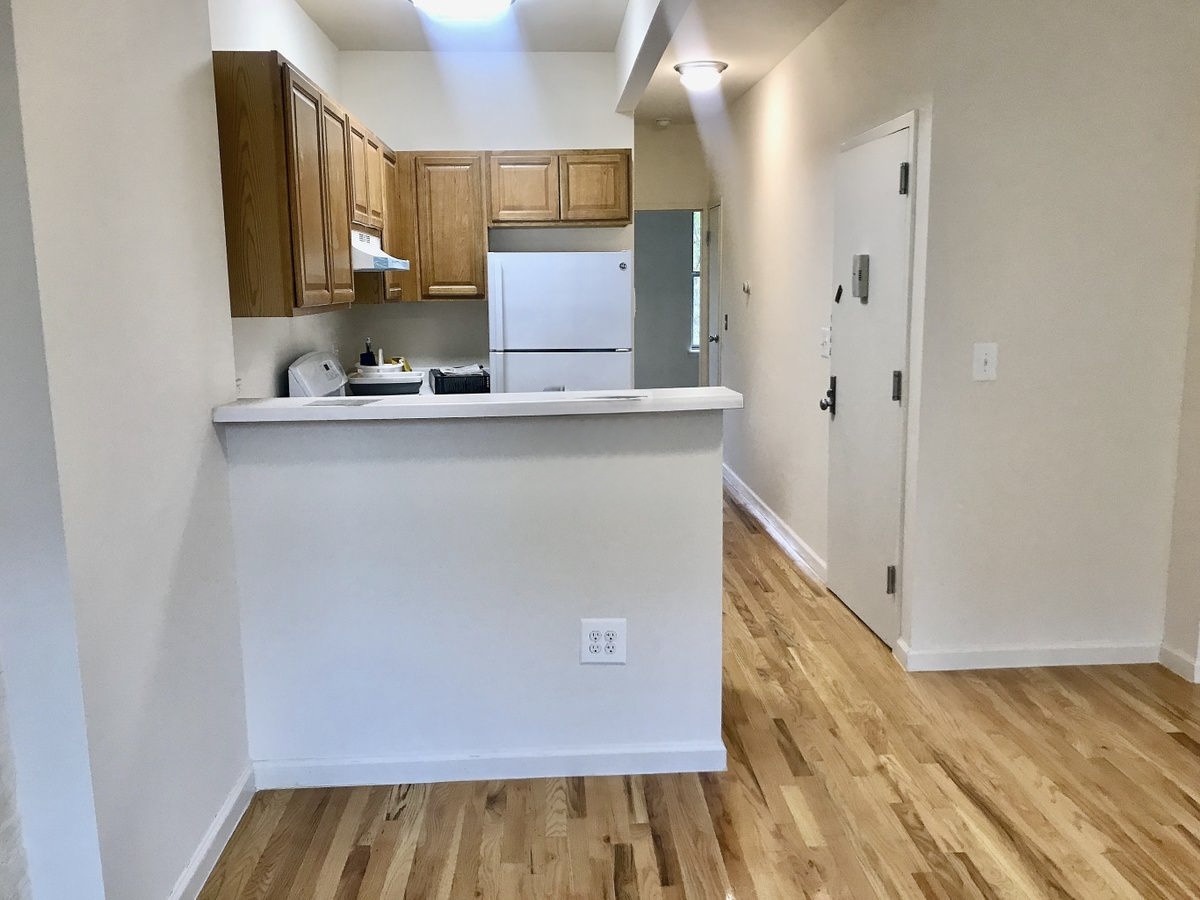 a view of kitchen with cabinets