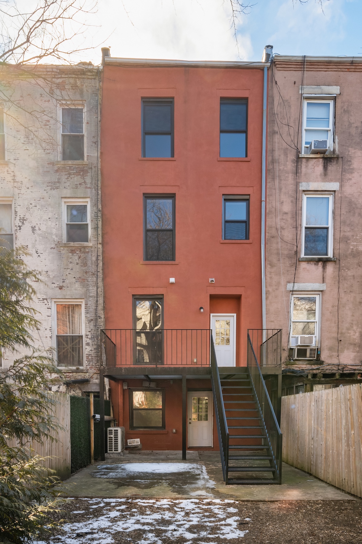 307 West 136th Street Manhattan, NY 10030 - Photo 24 of 26 a front view of a building with a yard