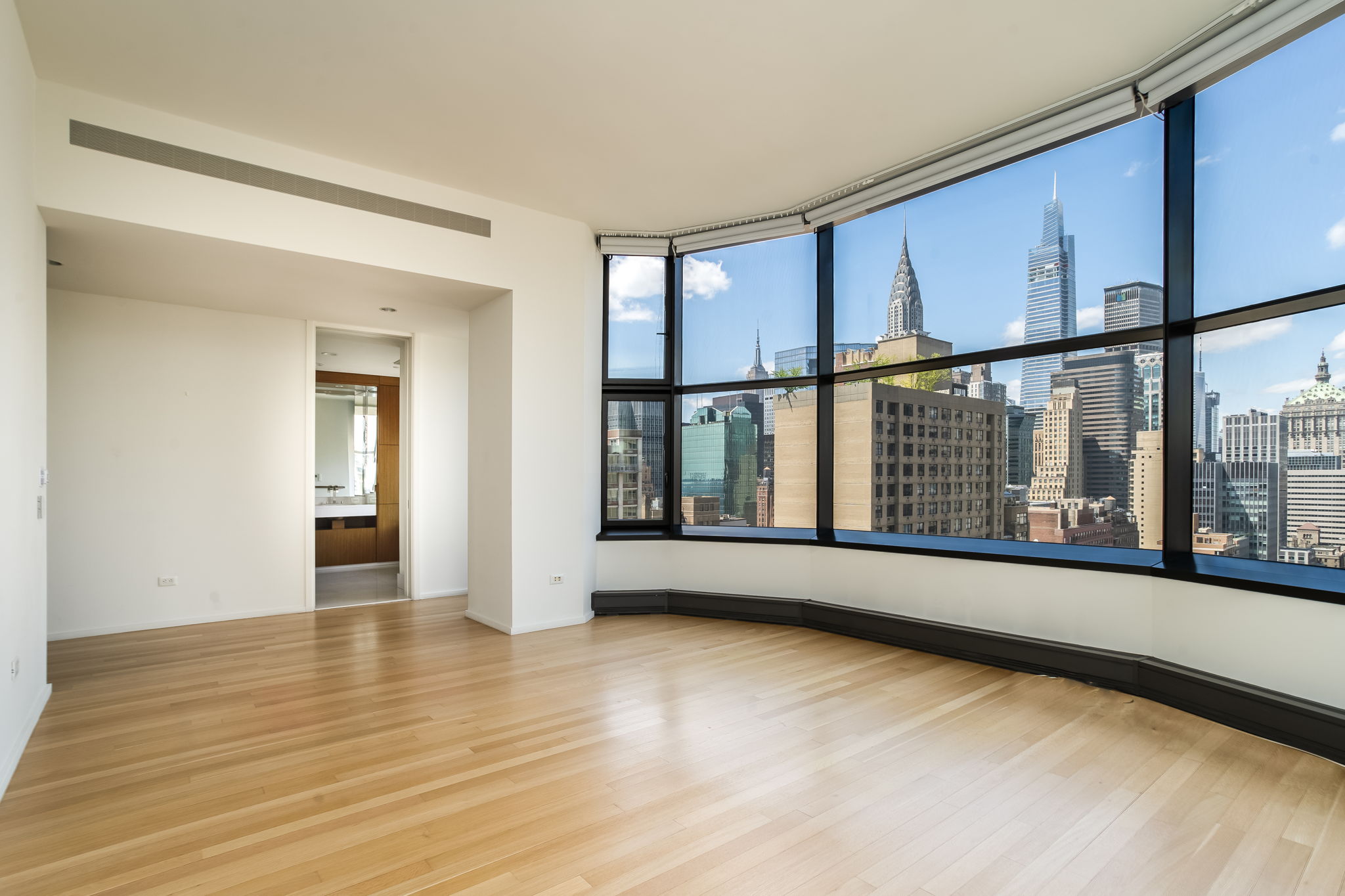 50 United Nations Plaza, Unit 26B Manhattan, NY 10017 - Photo 16 of 25 a view of an empty room with wooden floor and a window