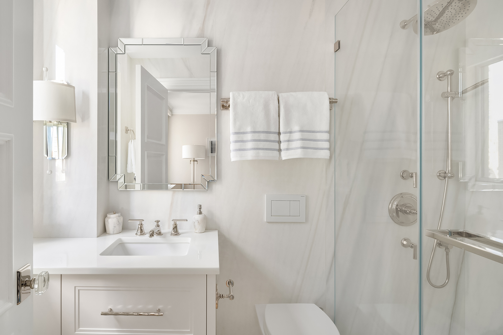 930 5th Avenue, Unit 18A Manhattan, NY 10021 - Photo 13 of 16 a bathroom with a sink toilet a mirror and shower