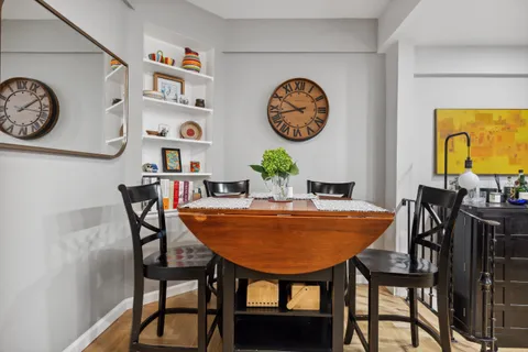 a dining room with furniture and wooden floor