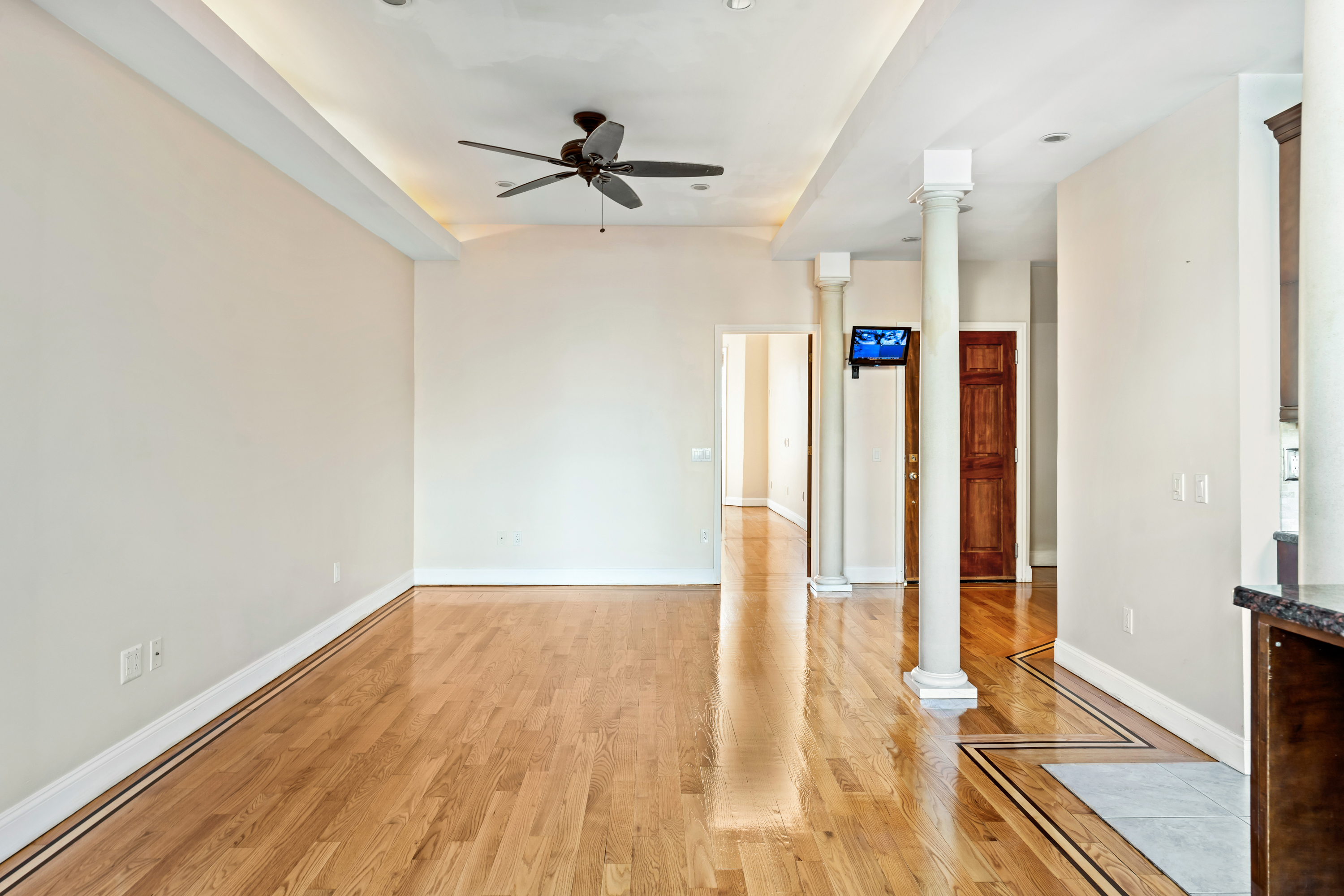 60-13 Menahan Street, Unit 1 Queens, NY 11385 - Photo 8 of 19 a view of empty room with wooden floor and fan
