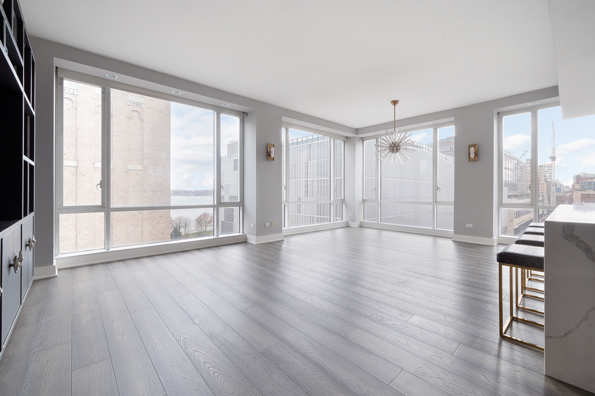 330 Spring Street, Unit 8B Manhattan, NY 10013 - Photo 7 of 14 a view of an empty room with wooden floor and a window