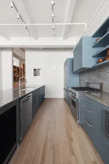 a large kitchen with stainless steel appliances granite countertop a stove and a sink