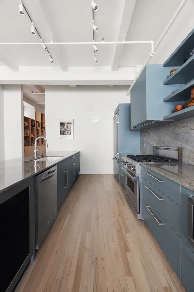 a large kitchen with stainless steel appliances granite countertop a stove and a sink