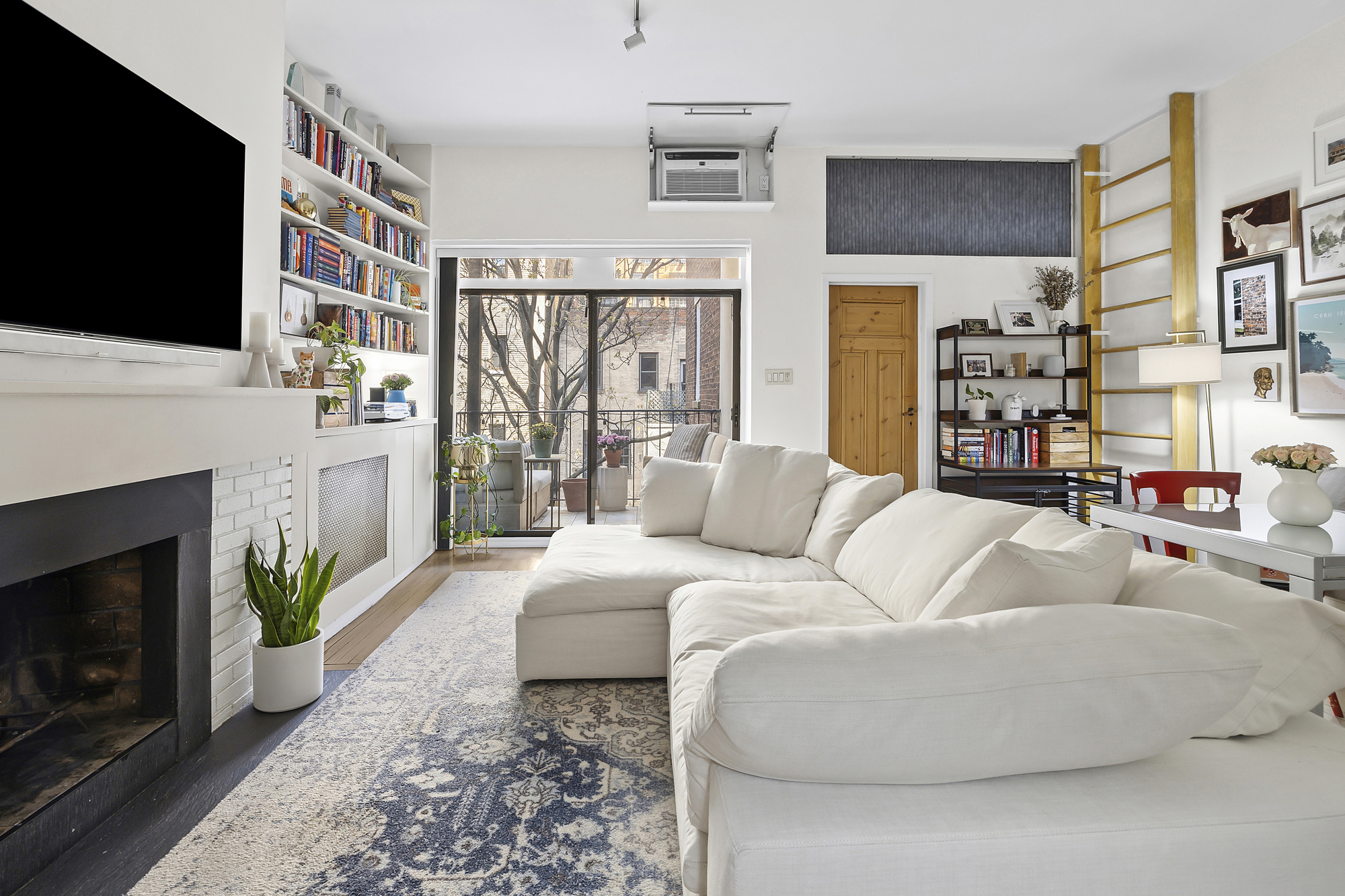 19 West 85th Street, Unit 3B Manhattan, NY 10024 - Photo 2 of 12 a living room with furniture a flat screen tv and a fireplace