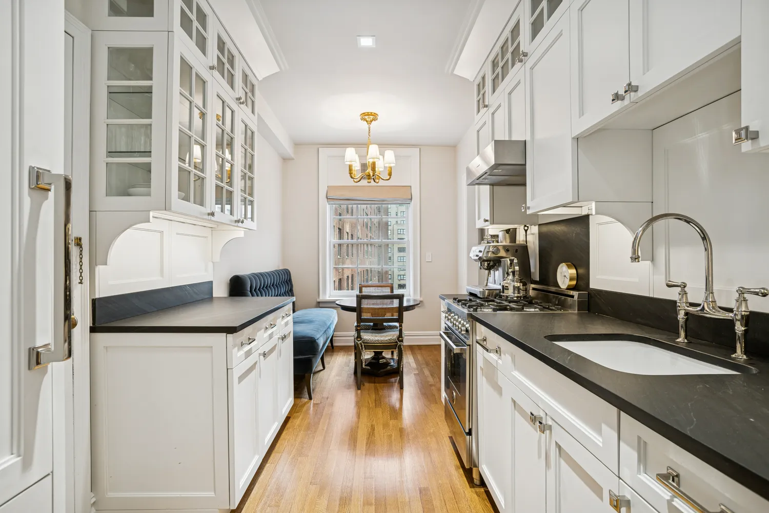 a kitchen with granite countertop a sink stove and cabinets