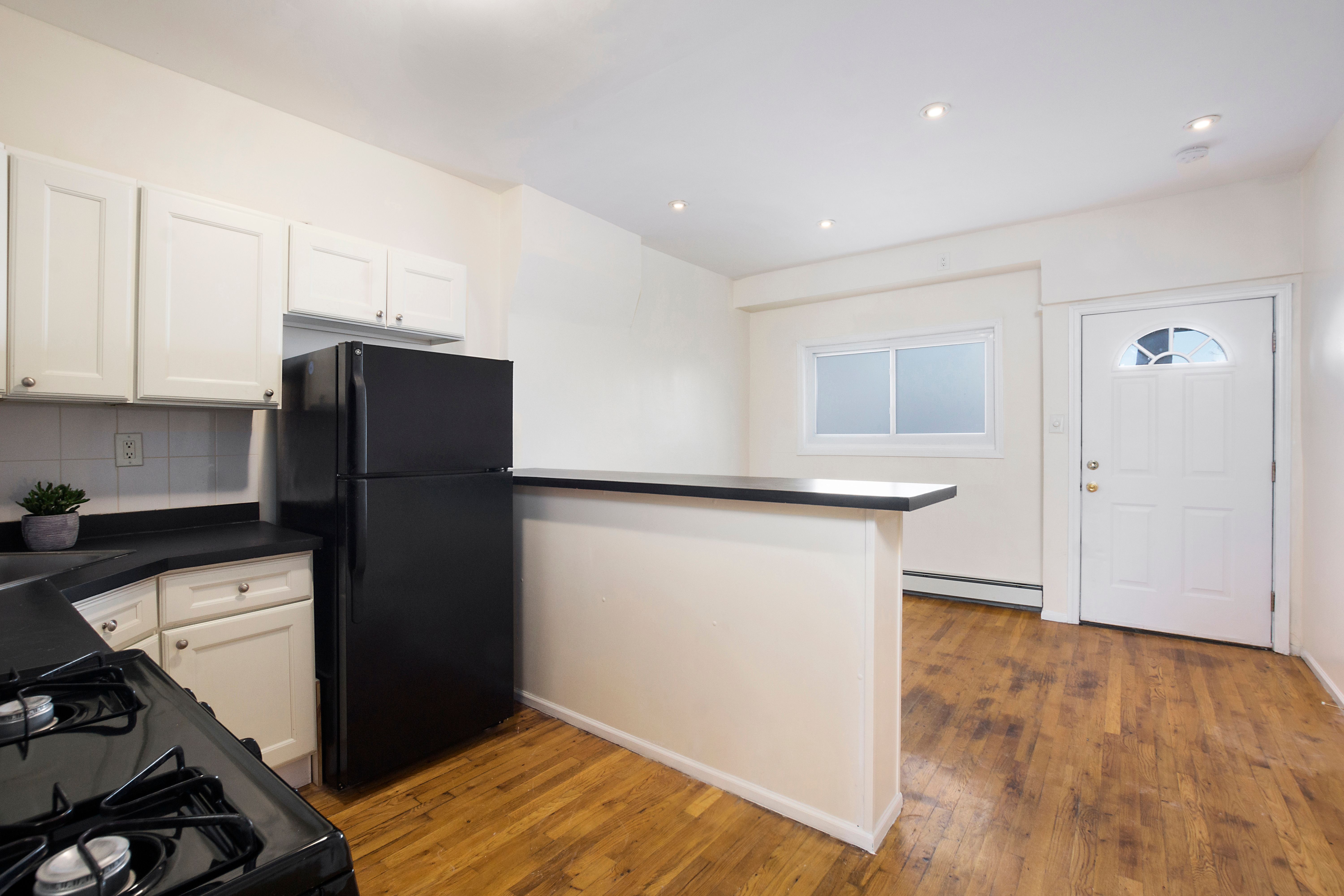 148 29th Street Brooklyn, NY 11232 - Photo 19 of 31 a kitchen with a refrigerator and a sink