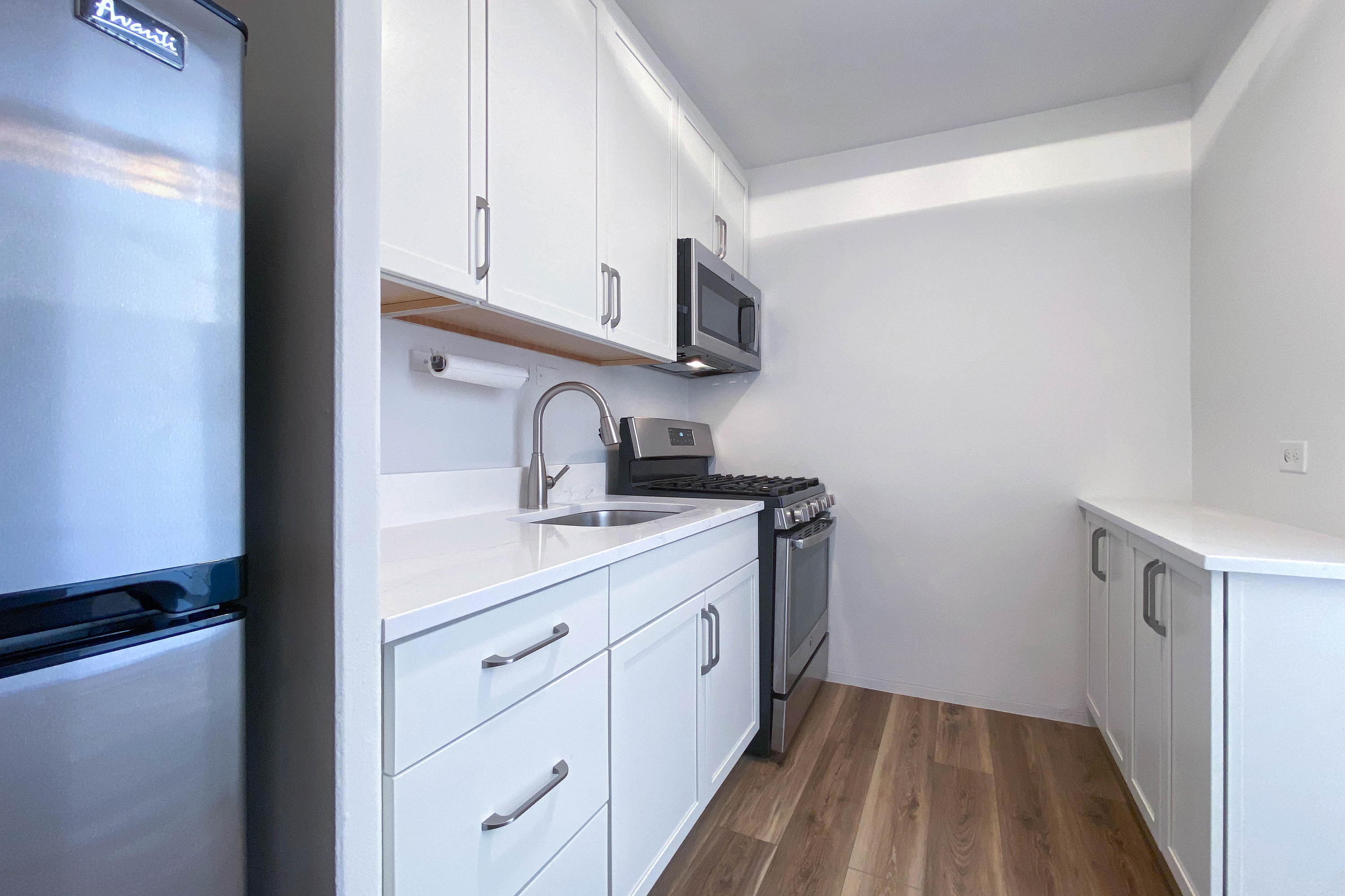 343 East 30th Street, Unit 4F Manhattan, NY 10016 - Photo 5 of 16 a kitchen with a sink cabinets and a window