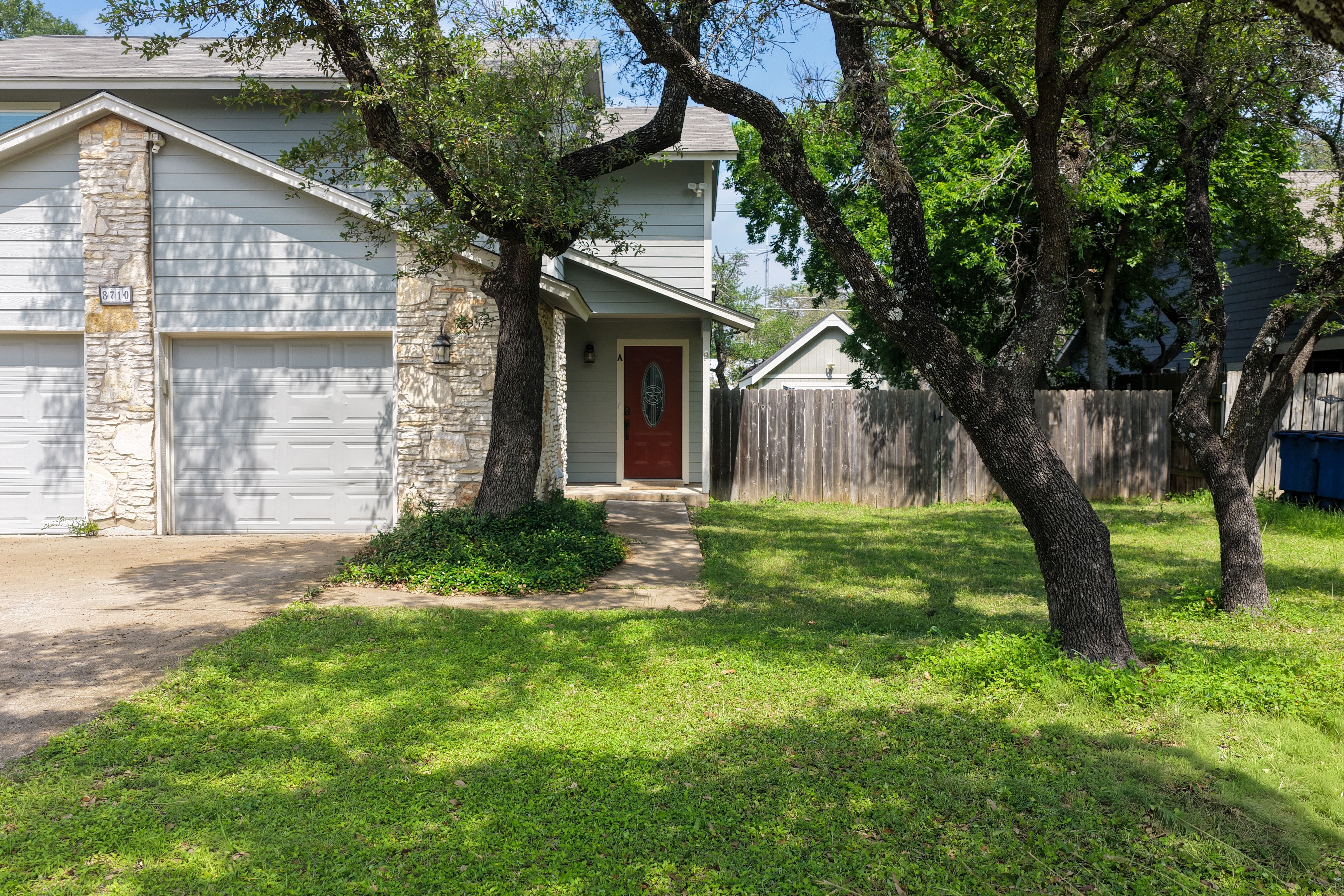 8710 Clearbrook Trail Austin, TX 78729 - Photo 1 of 28 a brick house with a tree in front of it