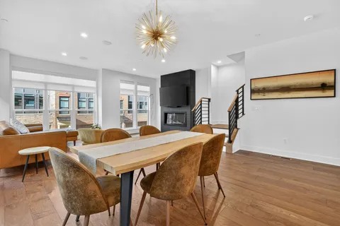 a view of a dining room with furniture and wooden floor