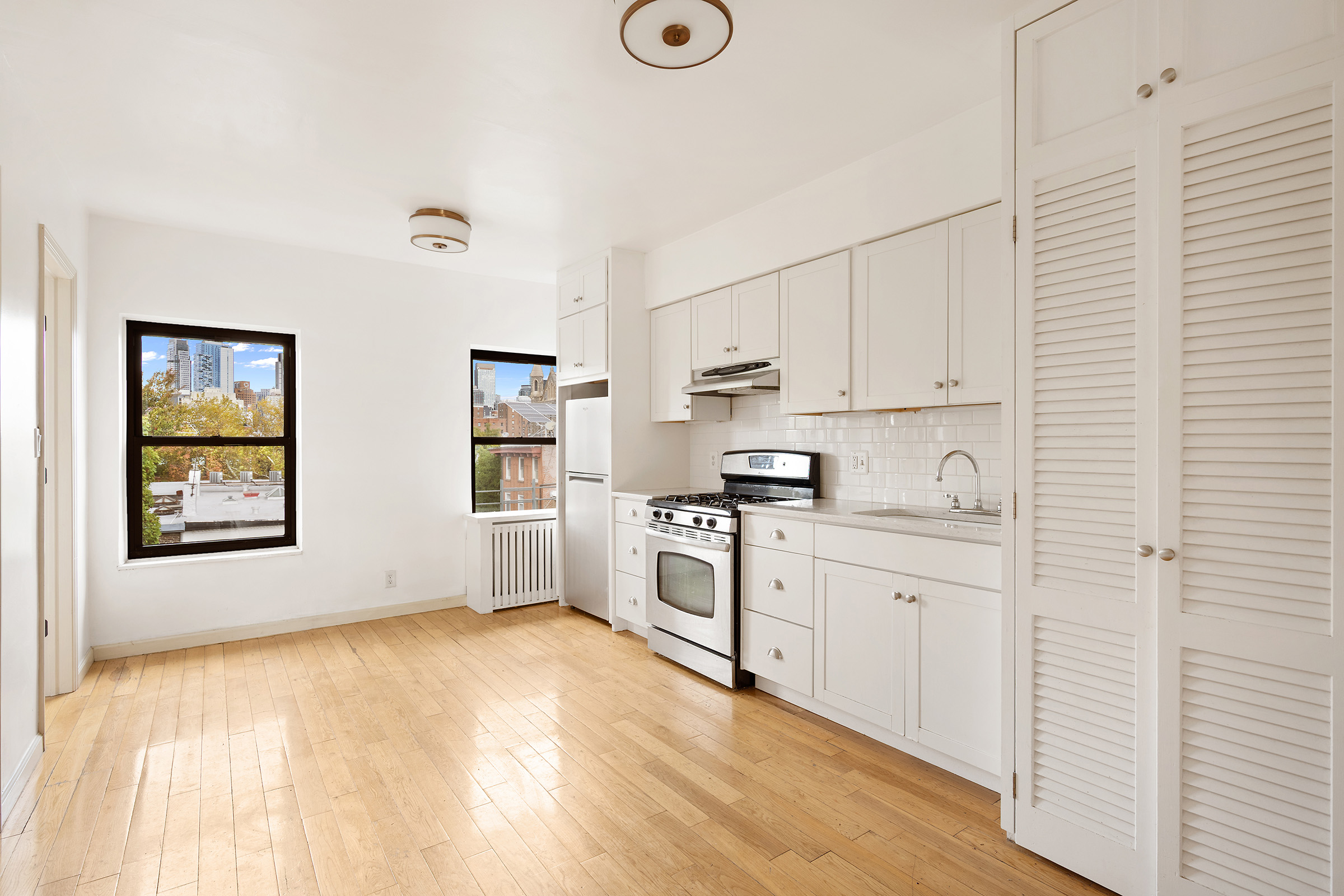 403 Union Street, Unit TOP Brooklyn, NY 11231 - Photo 4 of 7 a kitchen with stainless steel appliances granite countertop a sink and cabinets with wooden floor